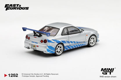Mini GT 1:64 Fast & Furious Nissan Skyline GT-R R34 Silver MGT01252-BL diecast model car rear view with blue graphics, Toyo Tires branding and rear wing