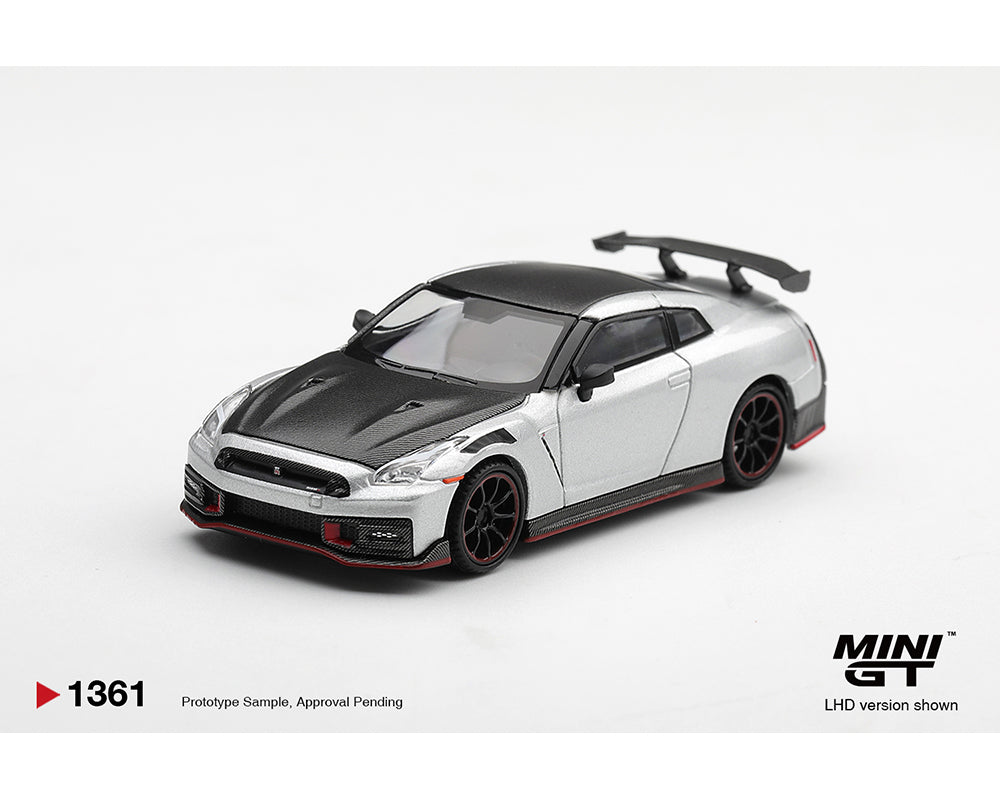 A miniature model of a Nissan GT-R sports car in silver and black, featuring a black hood, black roof, black wheels, and red accents on the front splitter and side skirts. The model is displayed on a clean white background with 'MINI GT' branding in the bottom right corner.