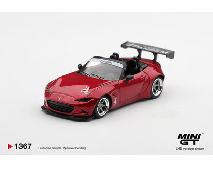 A red miniature model car, specifically a Mazda MX-5 Miata with a large rear wing and black interior, shown on a white background with 'MINI GT' branding and product code '1367' in the lower corners.