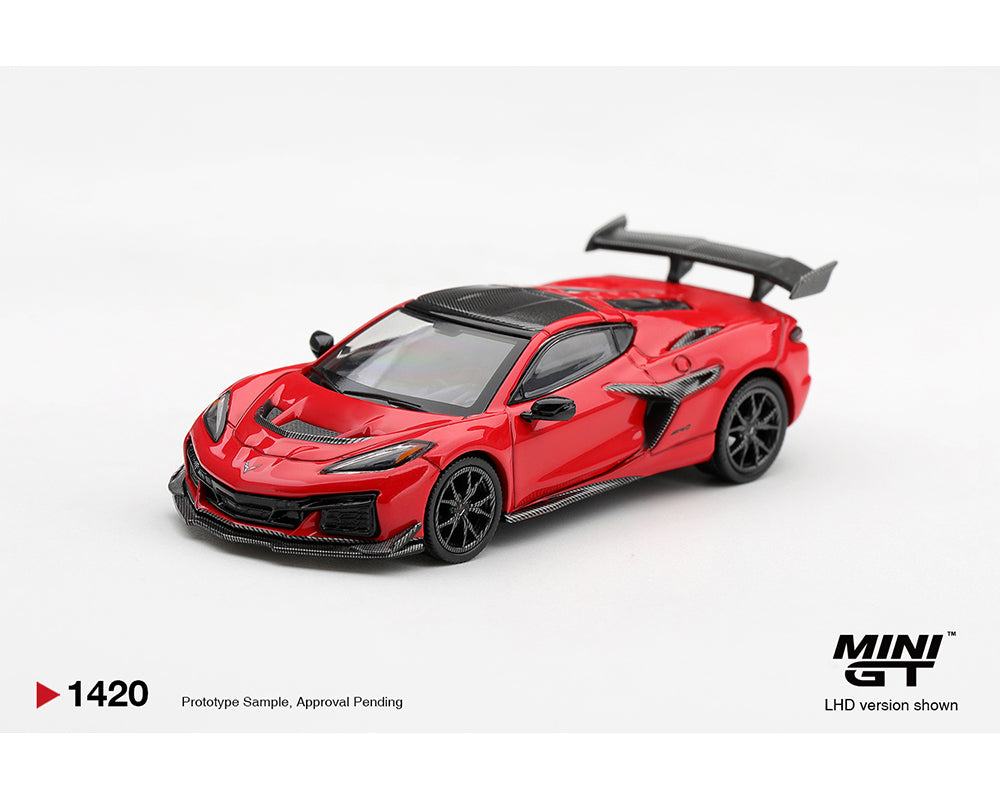 MINI GT 1:64 Chevrolet Corvette ZR1 Red diecast model car MGT01420-BL, front three-quarter view featuring carbon fiber hood accents, black wheels, aggressive front splitter, side air intakes, and large rear wing.