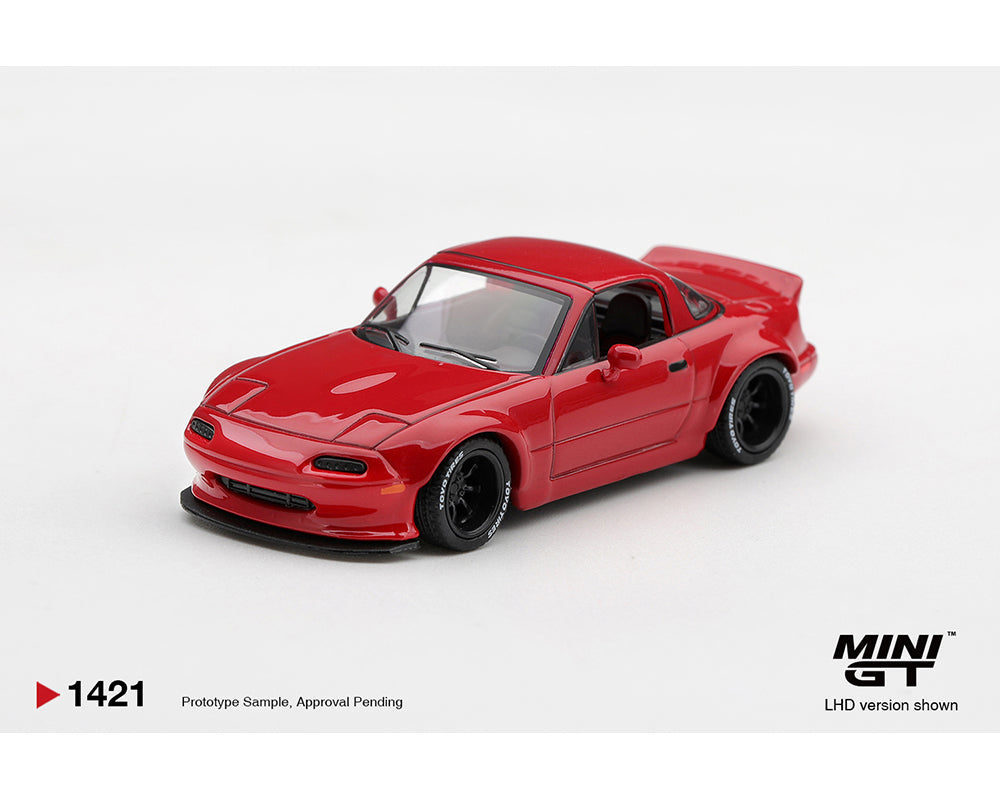 MINI GT 1:64 Mazda MX-5 Miata NA Red modified diecast model MGT01421-BL, front three-quarter view featuring widebody fenders, black racing wheels with white tire lettering, lowered stance, front splitter, and rear spoiler.
