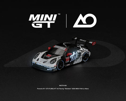 Mini GT 1:64 Porsche 911 GT3 R 992 #77 AO Racing Skeleton Rexy 2026 IMSA Petit Le Mans diecast model with glow-in-the-dark skeleton livery, MGT01436-BL.