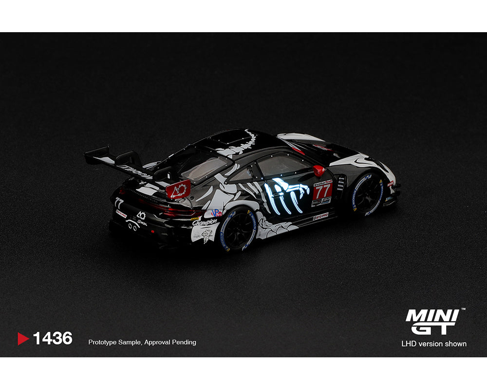 Mini GT 1:64 Porsche 911 GT3 R (992) #77 AO Racing Skeleton Rexy 2026 IMSA Petit Le Mans MGT01436-BL diecast model, rear three-quarter view featuring black and white skeleton livery, illuminated blue graphics and racing rear wing.