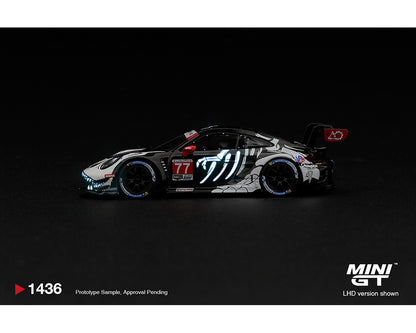 Mini GT 1:64 Porsche 911 GT3 R (992) #77 AO Racing Skeleton Rexy 2026 IMSA Petit Le Mans MGT01436-BL diecast model, side profile showing glow-in-the-dark blue skeleton graphics, black and white racing livery, Michelin tires and rear wing.