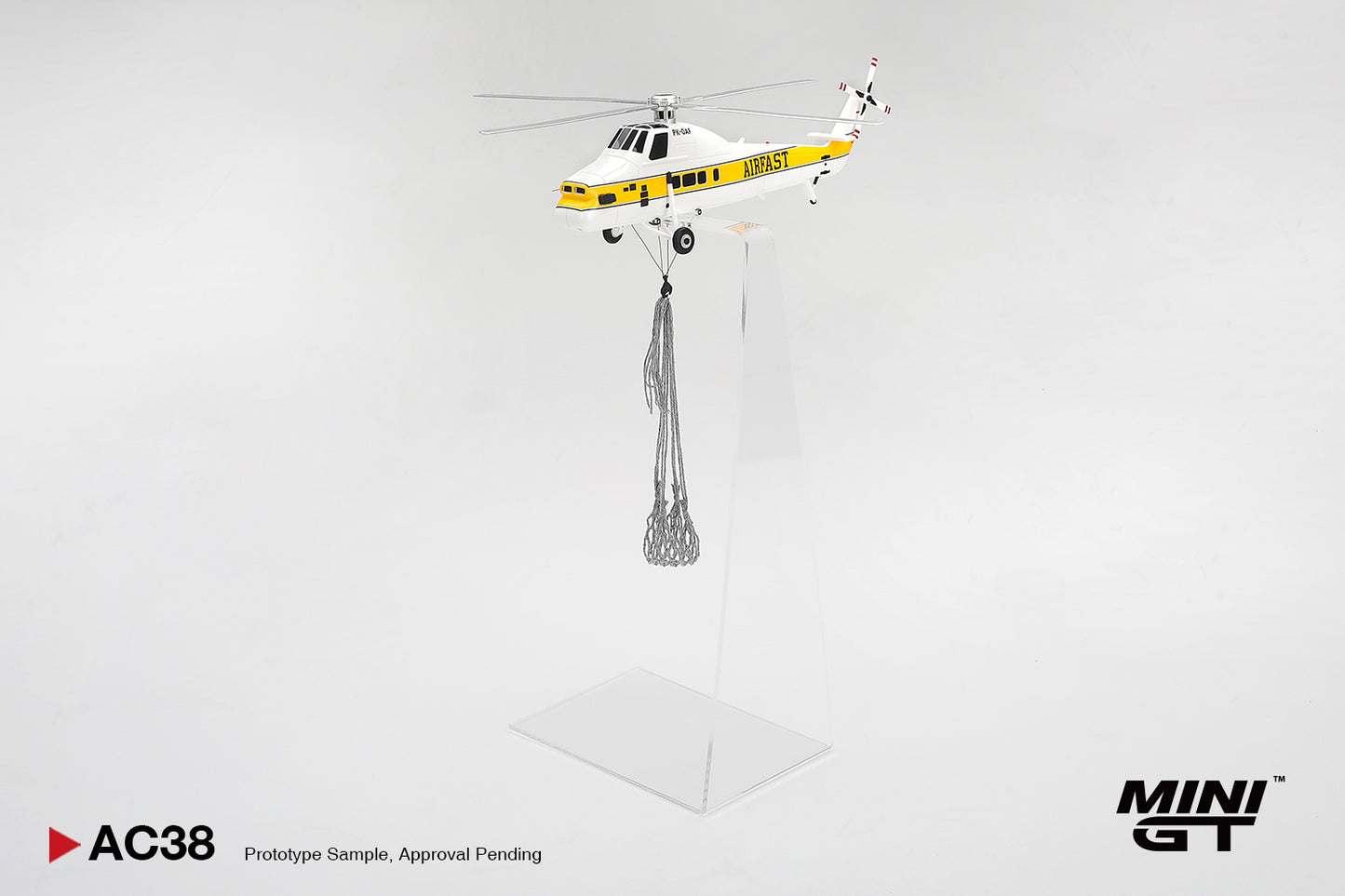 Model helicopter with a yellow and black design on a white background, featuring the Mini GT brand.