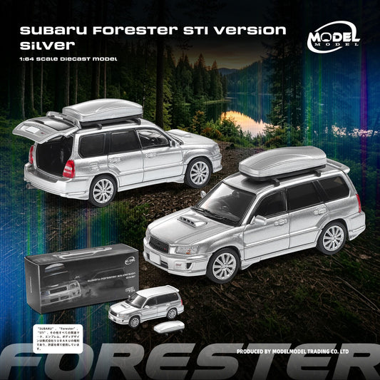 Silver 1:64 scale diecast model of a Subaru Forester STI, shown in two views (one with the trunk open and one parked) alongside its packaging box and accessories on a dark forest background.