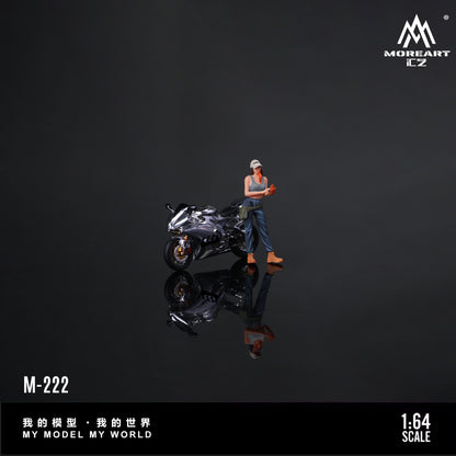 Miniature figure of a person with a motorcycle on a reflective surface with 'MOREART CZ' branding.