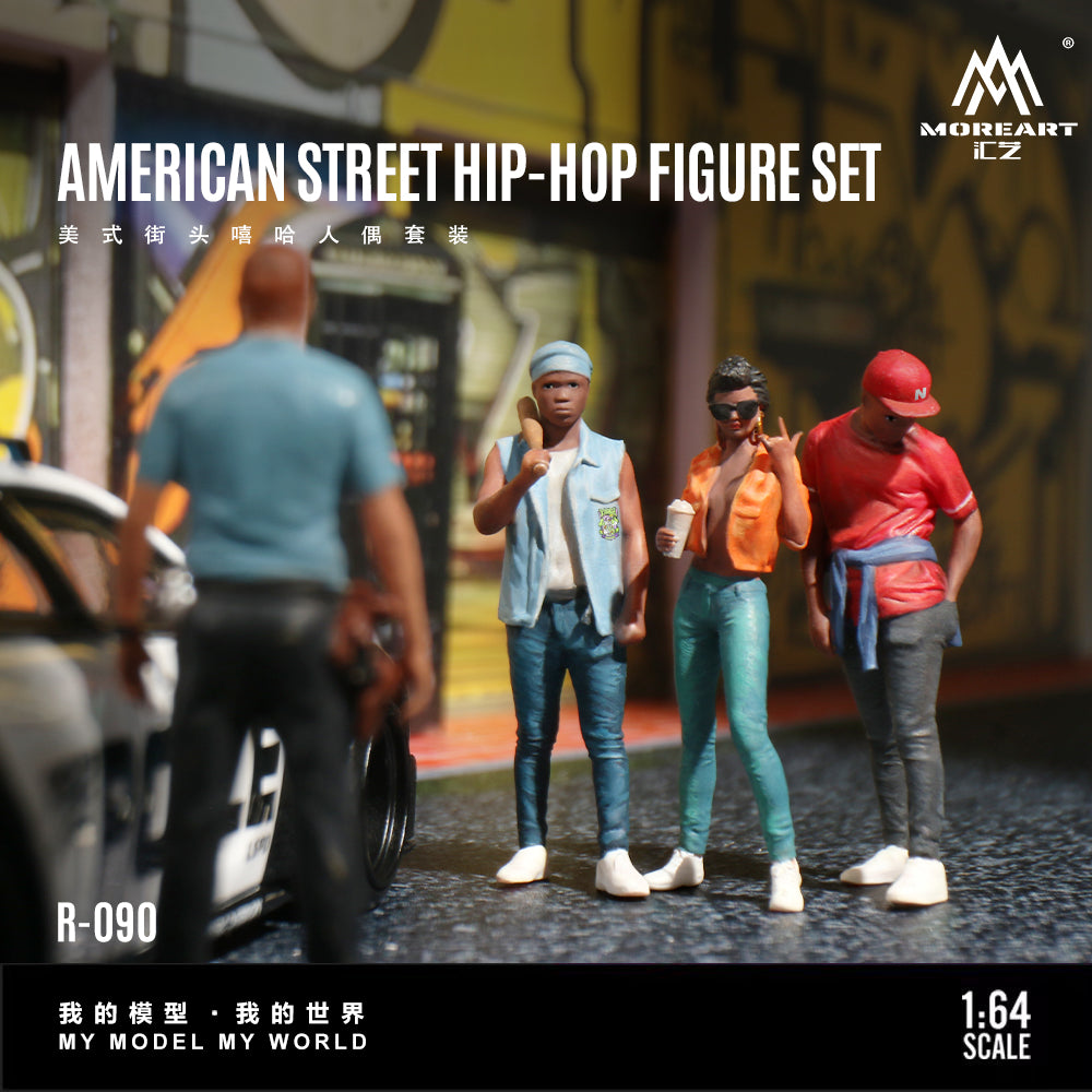 Model figures of three people in street fashion with a car and police car in an urban setting, featuring the brand 'MoreArt'.