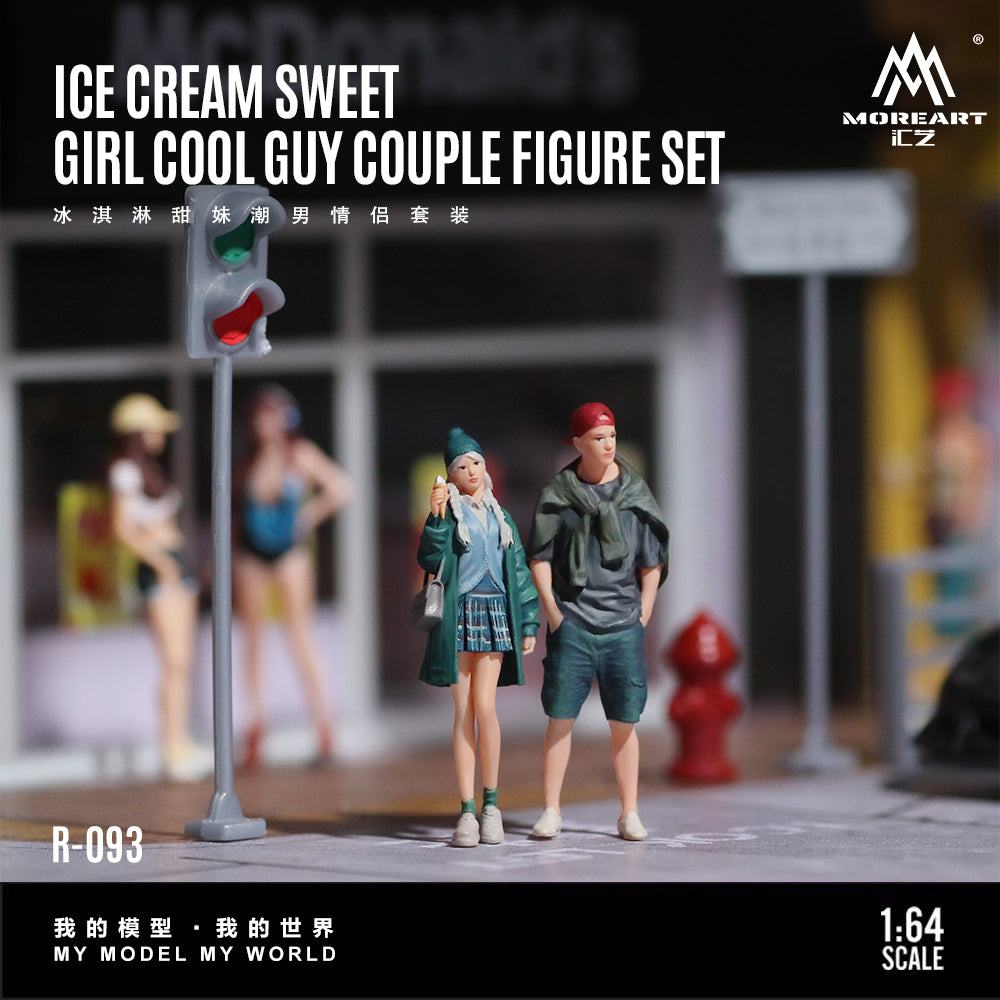 Model figure set of a girl and a guy on a street corner with a traffic light, featuring the brand 'MoreArt'.