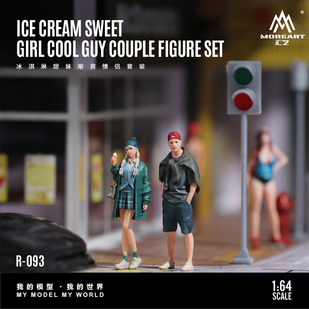 Model figure set of a girl and a guy in a city street scene with a traffic light.