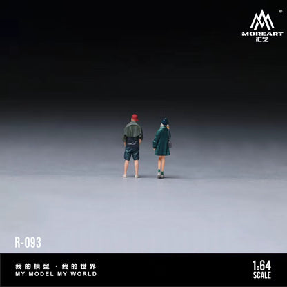 Two miniature figures standing on a gray surface with 'MOREART' branding.