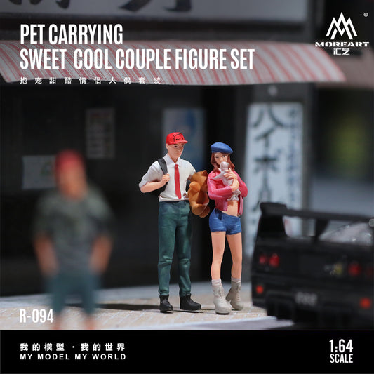 Model figure set of a couple with a pet, standing on a street with blurred background
