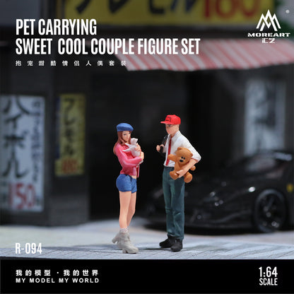 Model figure set of a couple with a pet, standing in front of a blurred urban background.