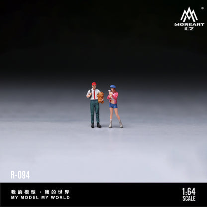 Two miniature figures standing on a gray surface with a dark background, featuring the brand 'MOREART'.
