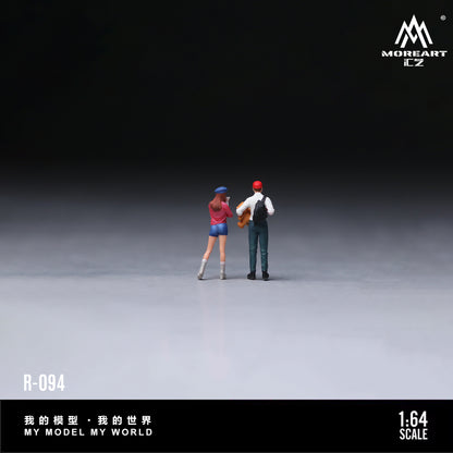 Two miniature figures standing on a gray surface with a dark background, featuring the brand 'MOREART'.