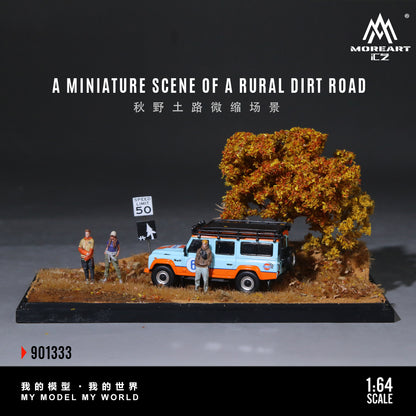 Model of a rural dirt road scene with a van, trees, and figures on a gray background.