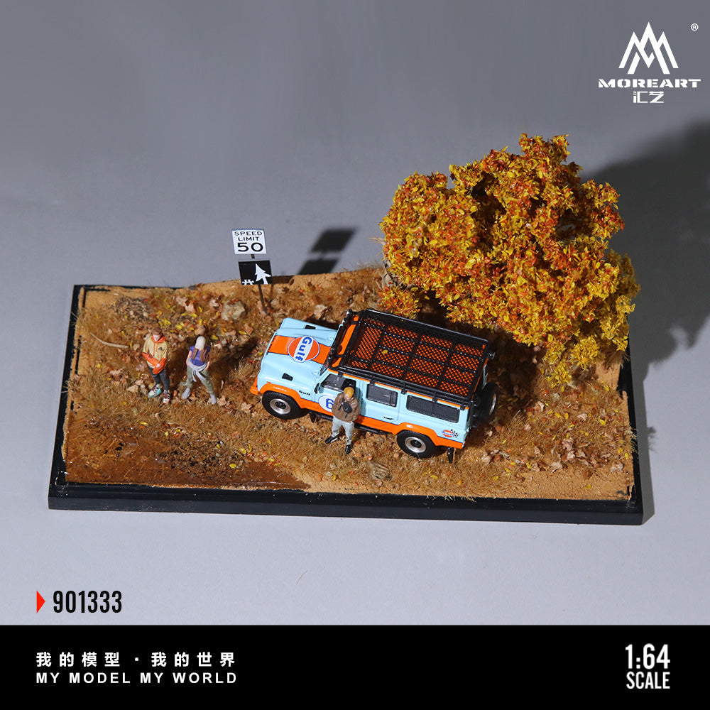 Model of a rural dirt road scene with a van, trees, and figures on a gray background.