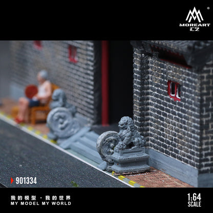 Model of a street scene with buildings and people, featuring MoreArt logo.