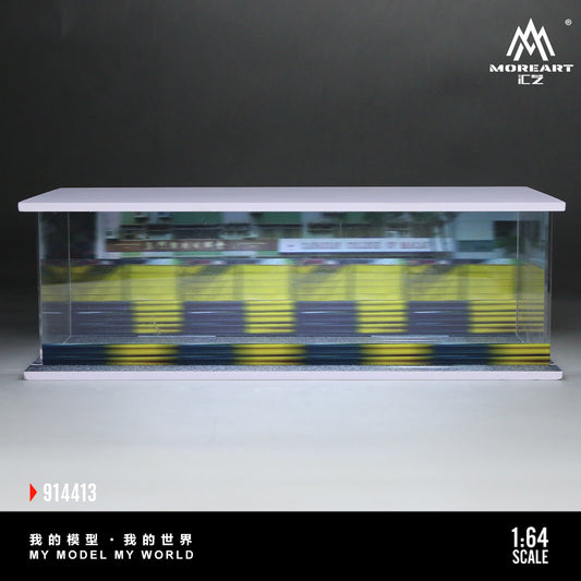 A 1:64 scale model displayed in a clear plastic case. The model features blurred yellow and black elements, suggesting movement. The scene conveys a dynamic, miniature world, with a backdrop of soft, neutral tones. Text in the image reads "My Model My World" and "914413."
