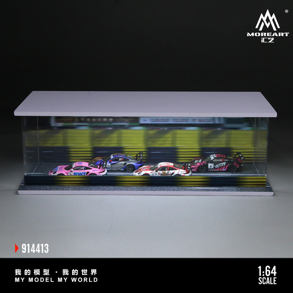 A display case containing four scale model race cars on a track. The cars are vibrant pink, blue, white, and red. Text reads "My Model My World."