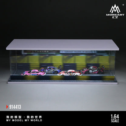 A display case containing four scale model race cars on a track. The cars are vibrant pink, blue, white, and red. Text reads "My Model My World."