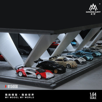 Collection of model cars on a display stand with 'MoreArt' branding.