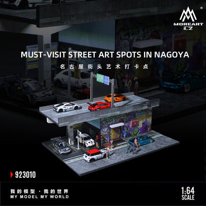 Model street scene with cars and street art in Nagoya, featuring MOREART CZ branding.