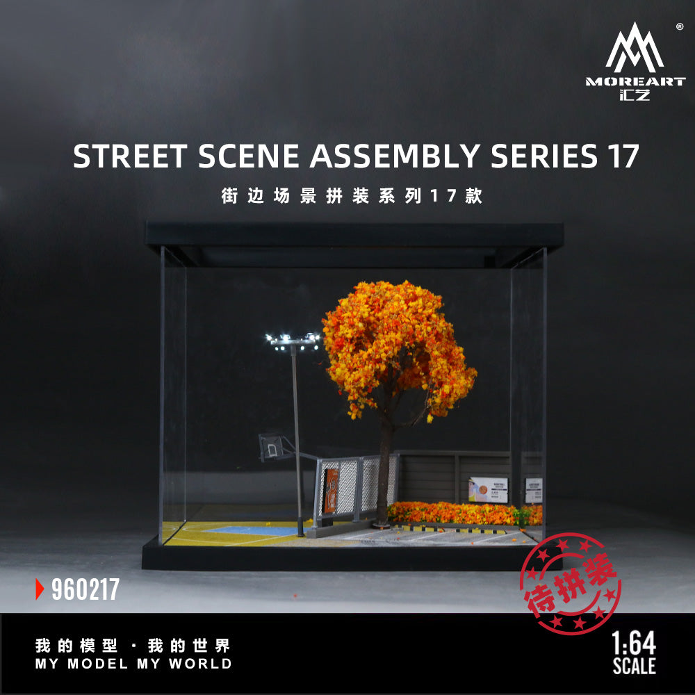 A 1:64 scale street scene assembly model set by MOREART, featuring a miniature basketball court with a bright orange tree, a light pole, and a small building, shown inside a clear display case against a dark background.