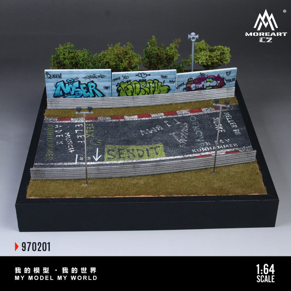 Model of a race track with cars and grass, featuring a brand logo.
