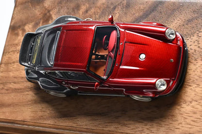 Red model car on a wooden surface