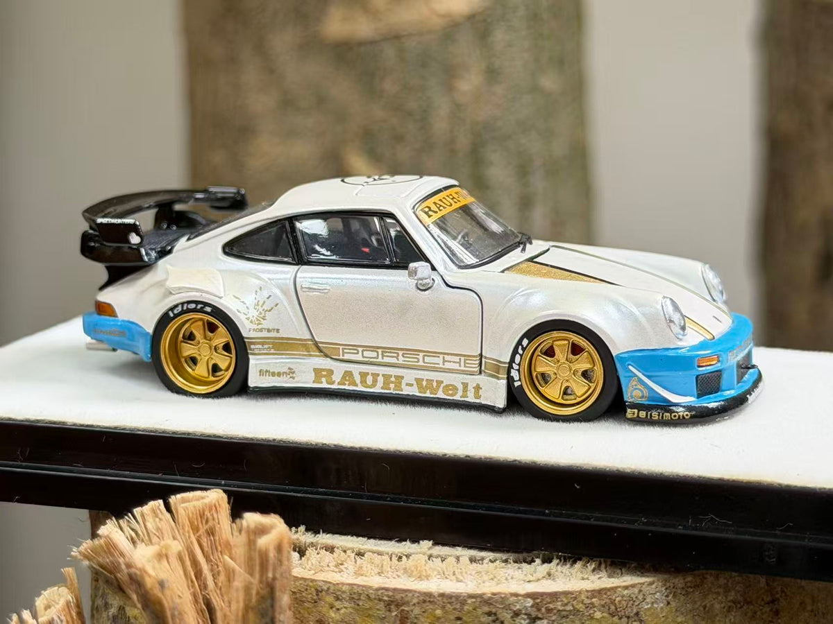 PGM 1:64 RWB Porsche 930 diecast model in pearl white with gold RAUH-Welt livery, blue bumpers, gold wheels and black rear wing