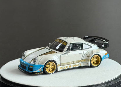 PGM 1:64 RWB Porsche 930 diecast model in pearl white with gold accents, blue bumpers, gold wheels and black rear wing