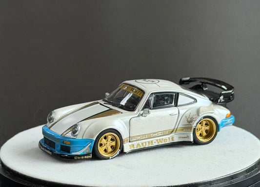 PGM 1:64 RWB Porsche 930 diecast model in pearl white with gold accents, blue bumpers, gold wheels and black rear wing