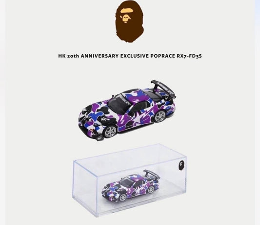Purple and black camouflage toy car with clear display box on a white background, featuring a brand logo.