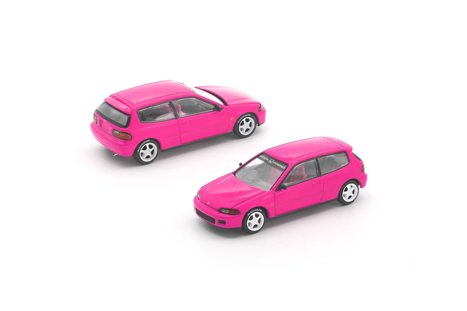 Two small, pink hatchback toy cars are positioned on a plain white background, one facing forward and the other facing backward.