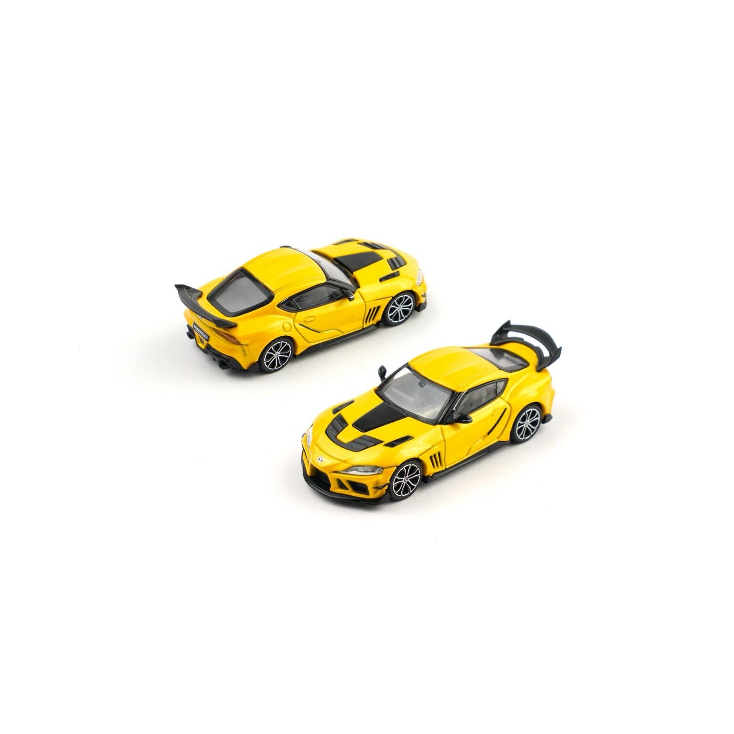 Two yellow model cars on a white background