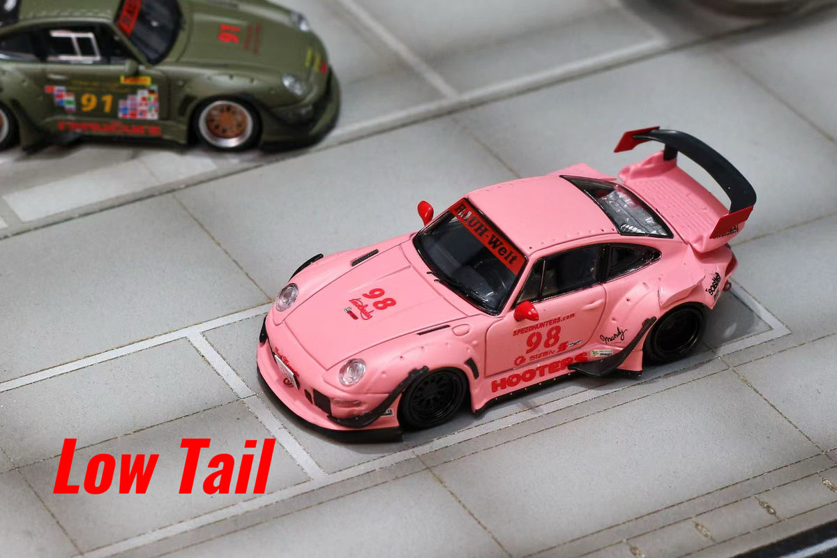 A pink model car with a large rear spoiler, shown on a gray tiled surface with a red 'Low Tail' text overlay. Another green model car is partially visible in the top left corner.