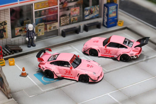 Two pink toy cars with open doors on a model street setup.
