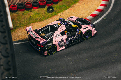Pink and black race car on a track with 'Pirelli' branding.
