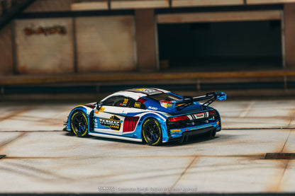 Model car on a wooden surface with a blurred background