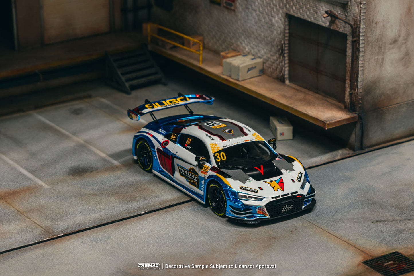 Model race car with colorful design on a concrete floor
