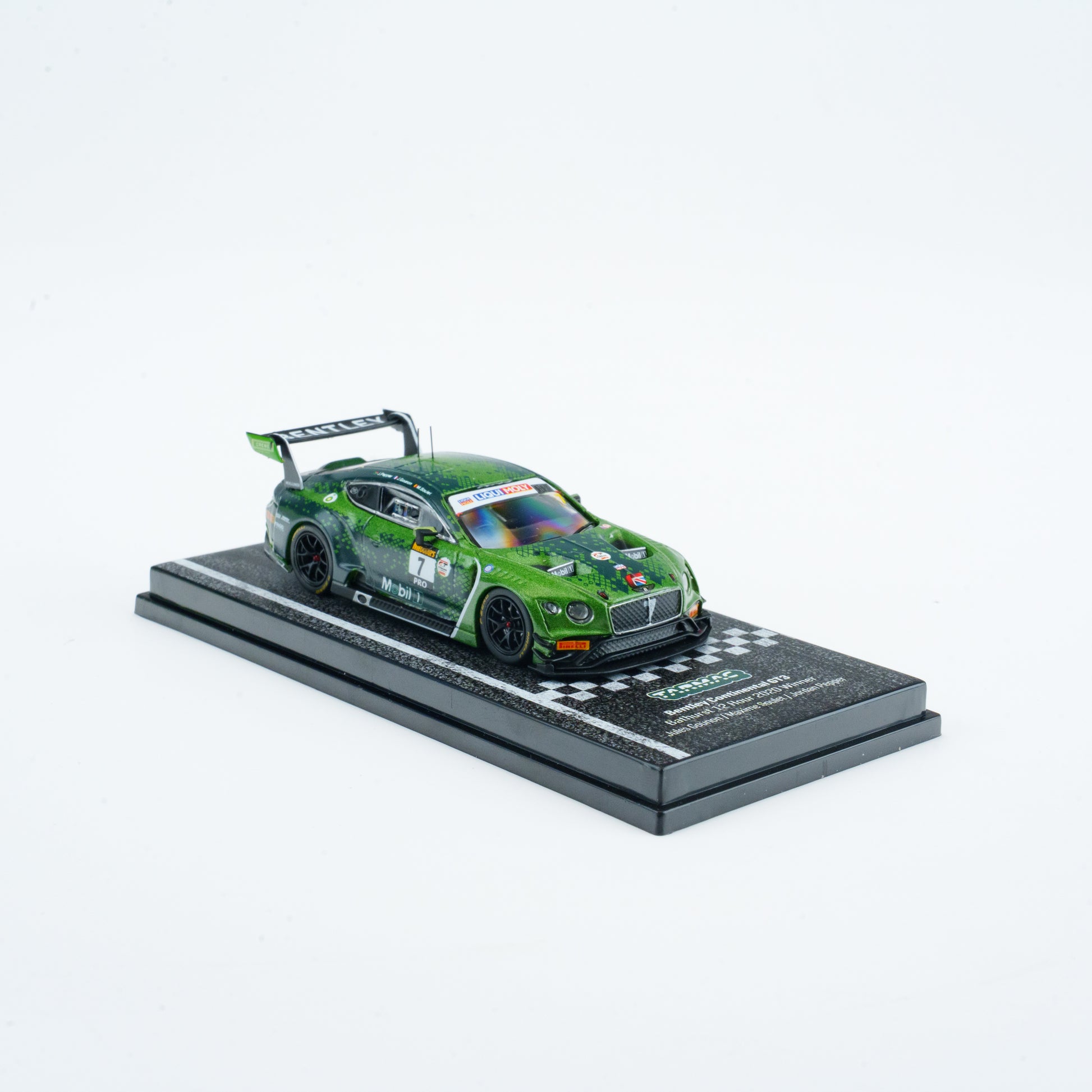 Green model car on a display stand with a white background