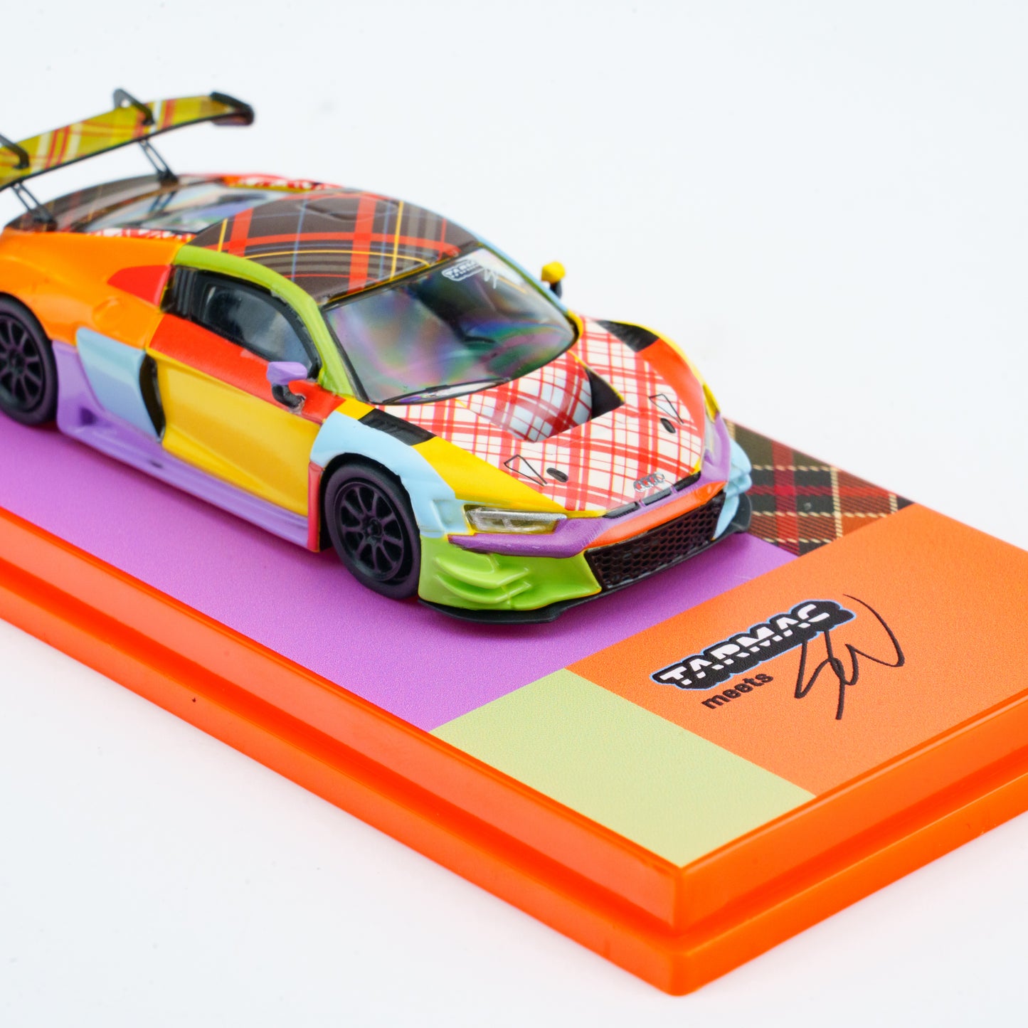 Colorful model car on a display stand with Tarmac Works branding