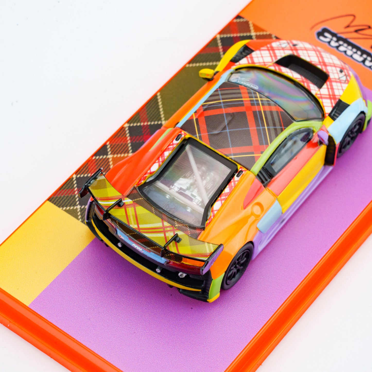 Colorful model car on a checkered background
