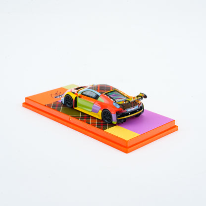 Colorful toy car on a patterned platform with a white background