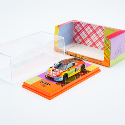 Colorful toy car on a display stand with a colorful box in the background
