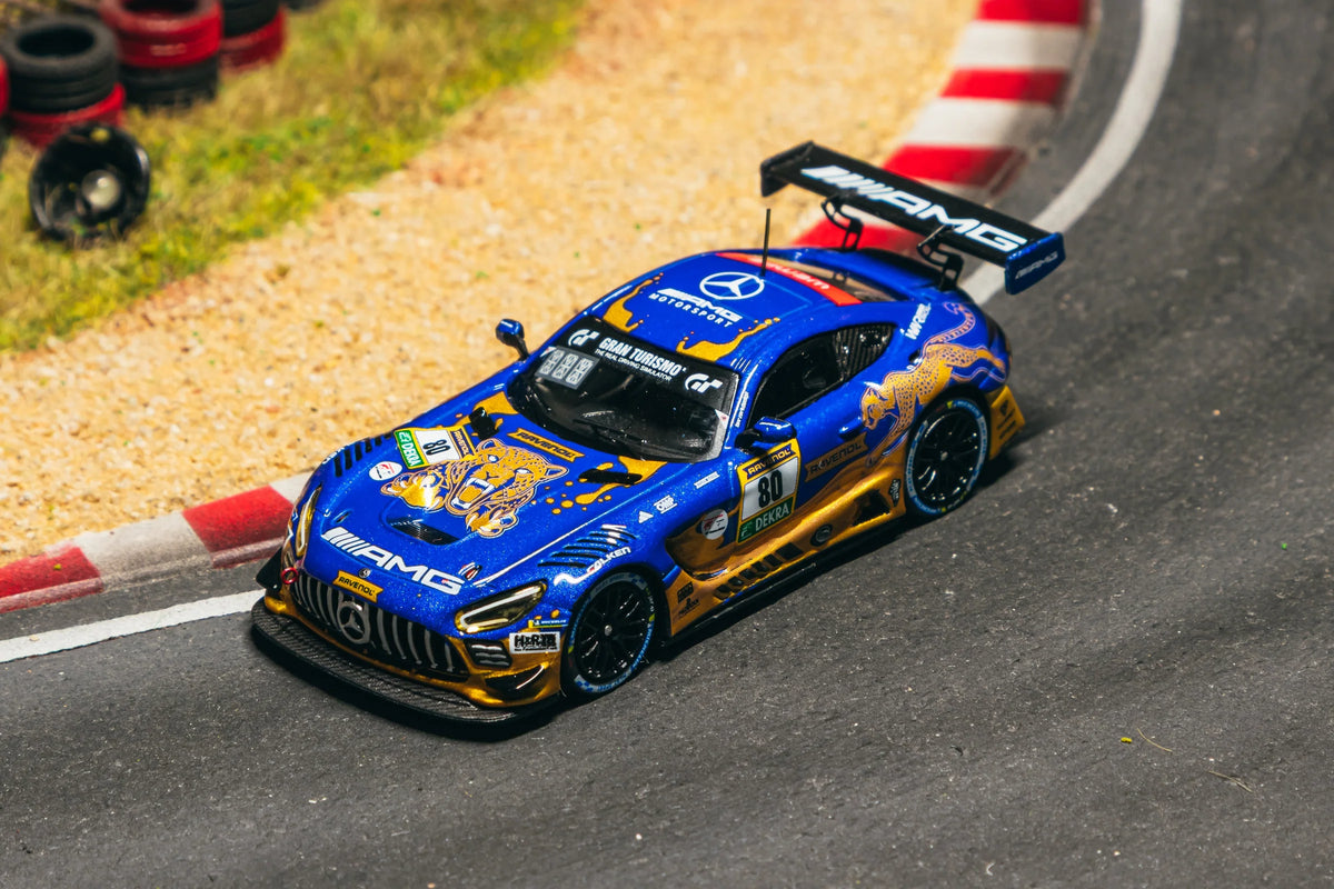 Model car on a race track with tires in the background