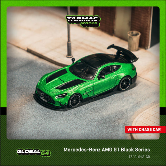 Green model car on a miniature street with Tarmac Works branding.