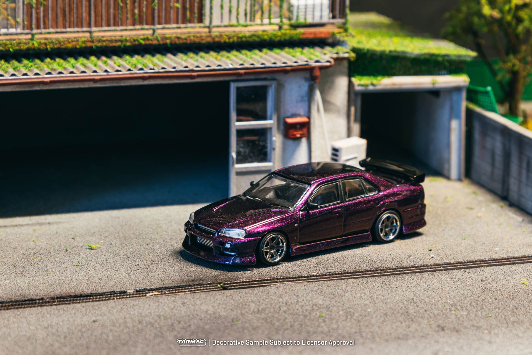 Model car on a miniature street with buildings in the background