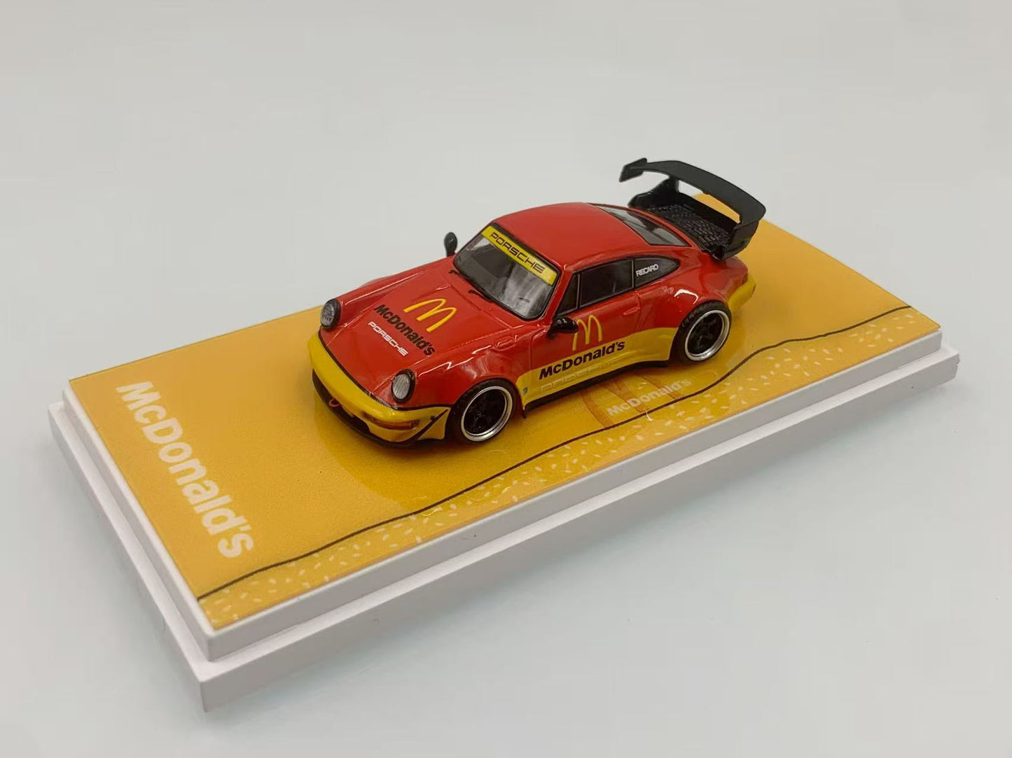 Model car on a McDonald's branded display stand with a plain background